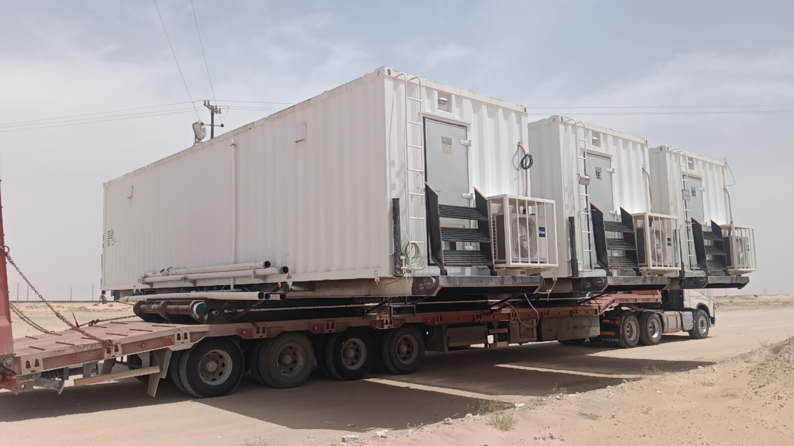 Triple cabin modules loaded on flatbed trailer